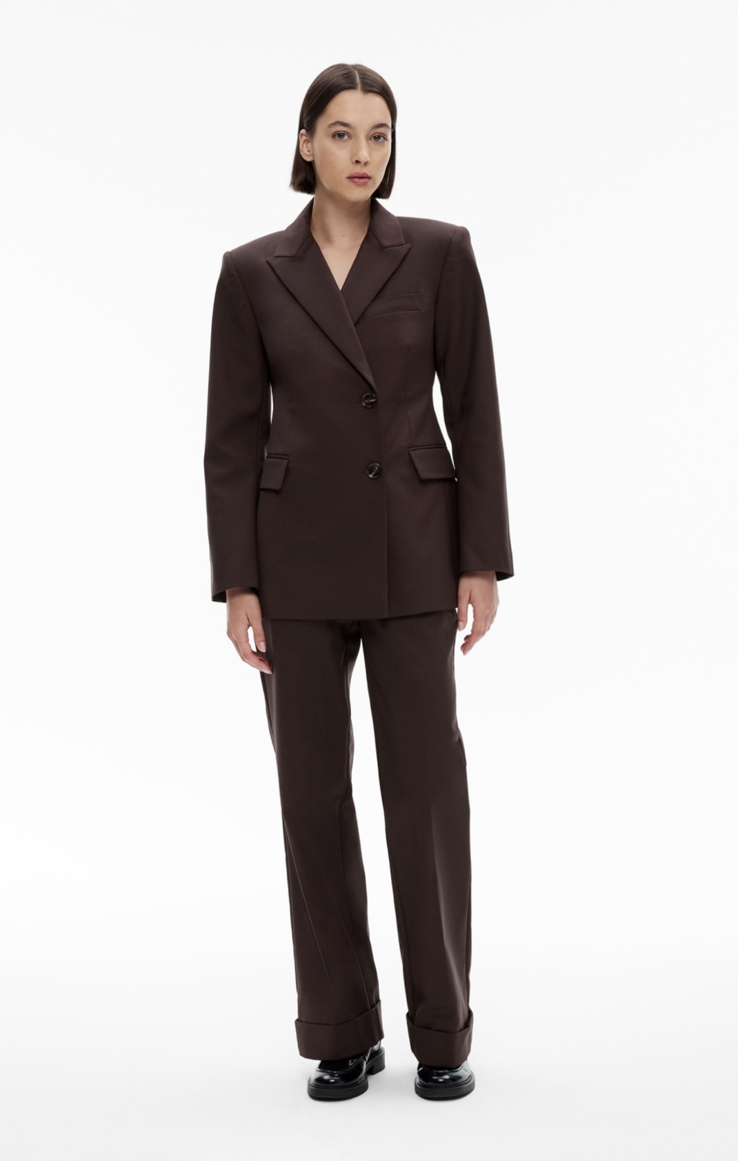 Woman in chocolate blazer and chocolate pants