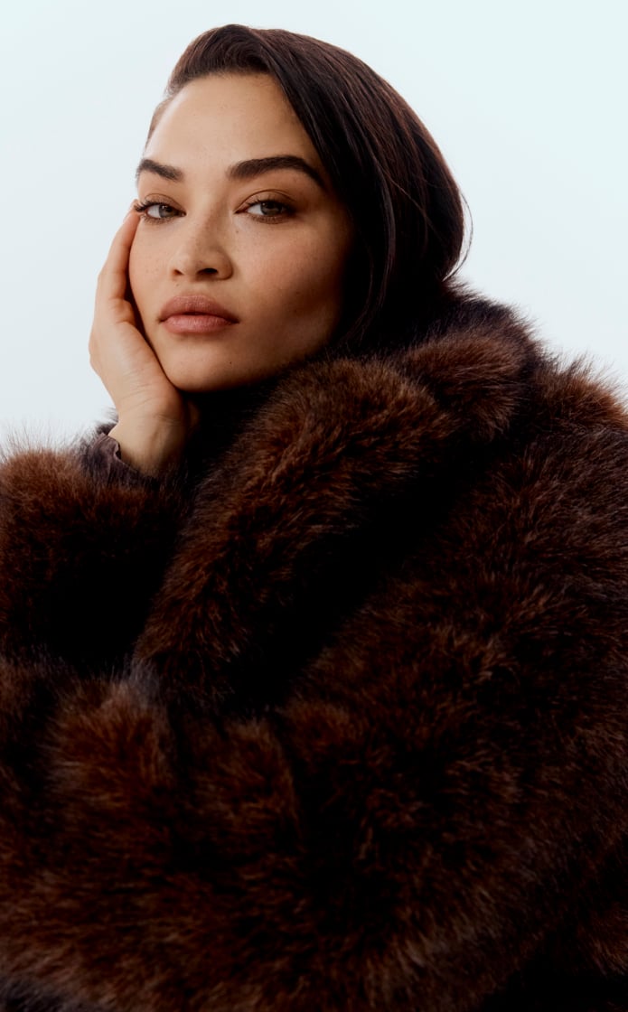 Shanina in faux fur jacket, and raisin acetate long sleeve midi dress