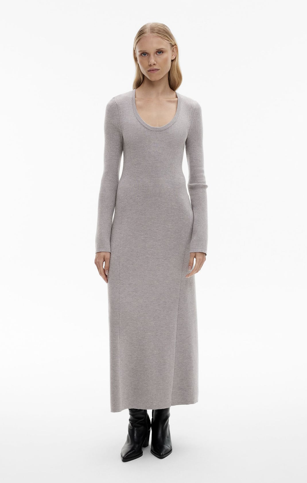 Woman in grey long sleeve knit dress and black boots