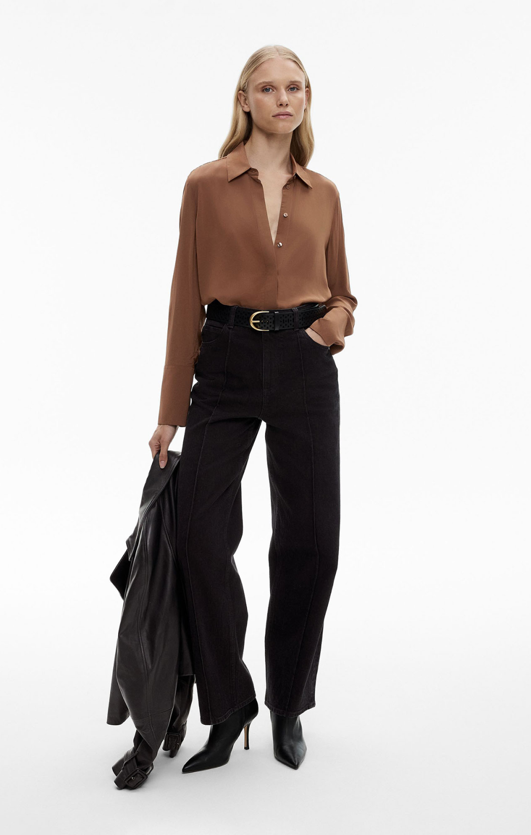 Woman in brown long sleeve shirt and black denim wide leg jeans
