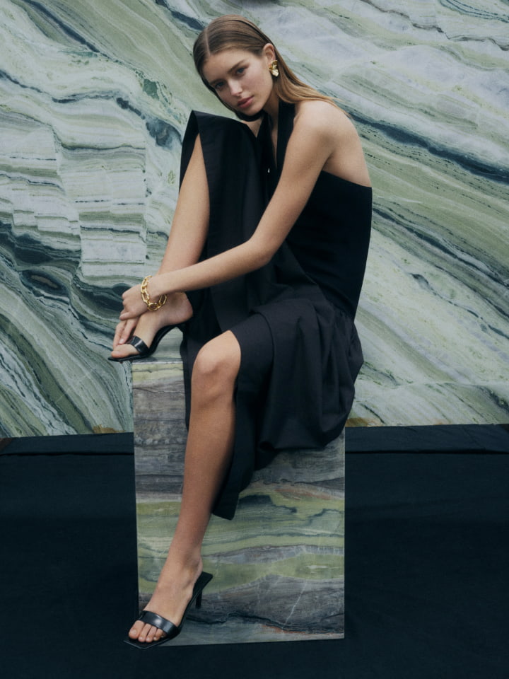 Woman in black halter maxi dress and black heels